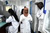 Scientific staff members works in a secure laboratory, researching the coronavirus, at the Pasteur Institute in Dakar on February 3, 2020. - The Pasteur Institute in Dakar, designated by the African Union as one of the two reference centres in Africa for the detection of the new coronavirus that appeared in China, is hosting experts from 15 countries on the continent this weekend to prepare them to deal with the disease. (Photo by Seyllou / AFP)