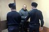FILE PHOTO: Dennis Christensen, a Jehovah's Witness accused of extremism, leaves after a court session in handcuffs in the town of Oryol, Russia January 14, 2019. REUTERS/Andrew Osborn/File Photo