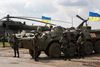 Ukrainske soldater ved deres pansrede mandskabsvogne med ukrainske flag tirsdag nær byen Izyum i det østlige Ukraine. På flere mindre flyvepladser i området er ukrainske soldater set myldre ud af helikoptere. Foto: Sergej Grits/AP