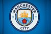 A logo is pictured outside the Etihad Stadium, the home ground of Manchester City football club, in Manchester, north-west England on September 30, 2026. The Premier League said on September 29 that Manchester City have been found guilty of serious breaches of the Premier League's financial rules over a nine-season period between 2009 and 2018. (Photo by Oli SCARFF / AFP)