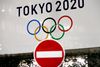 FILE PHOTO: A banner for the upcoming Tokyo 2020 Olympics is seen behind a traffic sign, following an outbreak of the coronavirus disease (COVID-19), in Tokyo, Japan, March 23, 2020. REUTERS/Issei Kato -/File Photo