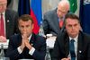 Emmanuel Macron og Jair Bolsonaro kan ikke døje hinanden, og under G7-mødet er de faret i struben på hinanden. Foto: Jacques Witt/AFP