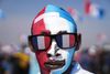 A Supporter of Rwanda's President Paul Kagame with his face painted with the colors of the political party attends his final election campaign rally in Kigali, Rwanda Saturday, July 13, 2024. Rwandans are voting Monday in an election that will almost certainly extend the long rule of Kagame, who is running virtually unopposed after three decades in power in the eastern African nation. (AP Photo/Brian Inganga)