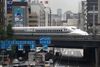 In this Sept. 24, 2014 photo, a Shinkansen bullet train heads for Tokyo Station near Shimbashi Station on the Tokaido Main Line in Tokyo. Japan launched its bullet train between Tokyo and Osaka 50 years ago Wednesday, Oct. 1, 2014. (AP Photo/Shizuo Kambayashi)