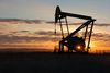 FILE - This Nov. 6, 2013 file photo shows a Whiting Petroleum Co. pump jack pulls crude oil from the Bakken region of the Northern Plains near Bainville, Mont. As the Trump administration rolls back environmental and safety rules for the U.S. energy sector, government projections show billions of dollars in savings reaped by companies will come at a steep cost: increased premature deaths and illnesses from air pollution, a jump in climate-warming emissions and more derailments of trains carrying explosive fuels. (AP Photo/Matthew Brown, File)