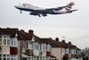 FILE - In this Tuesday, Oct. 25, 2016 file photo, a plane flies over nearby houses as it approaches for landing at Heathrow Airport in London. The British Cabinet on Tuesday June 5, 2018, is expected to approve the construction of a third runway at Heathrow Airport, and to put the long-running issue up for a parliamentary vote. (AP Photo/Frank Augstein, File)