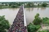Billeder fra et overvågningskamera viser tusinder af migranter, der venter på en bro over floden Suchiate. Broen forbinder Guatemala og Mexico. Grænseporten ind til Mexico for enden er broen er blevet lukket af de mexicanske myndigheder. Foto: Televisa/AP