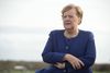 German Chancellor Angela Merkel is pictured standing in the wind after visiting the newly opened tourist information centre and inaugurating an electric bus, on the the island of Ummanz, near the island of Ruegen in north-eastern Germany, on October 25, 2019. (Photo by Stefan Sauer / dpa / AFP) / Germany OUT