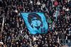 (FILES) In this file photo taken on January 07, 2013 SSC Napoli's fans display a flag with the effigy of Napoli's former Argentinian player Diego Armando Maradona during the Serie A football match SSC Napoli vs A.S. Roma at San Paolo Stadium in Naples. - Argentinian football legend Diego Maradona passed away on November 25, 2020. (Photo by ROBERTO SALOMONE / AFP)