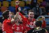 Denmark's players celebrate after winning the 2021 World Men's Handball Championship final match between Denmark and Sweden at the Cairo Stadium Sports Hall in the Egyptian capital on January 31, 2021. (Photo by Anne-Christine POUJOULAT / AFP)