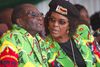 FILE - In this June, 2, 2017 file photo Zimbabwean President Robert Mugabe, left, and his wife Grace follow proceedings during a youth rally in Marondera Zimbabwe. (AP Photo/Tsvangirayi Mukwazhi, File)