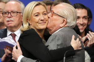 FILE - In this Sunday Nov. 30, 2014 file photo, French far-right Front National leader Marine Le Pen is kissed by her father Jean-Marie Le Pen in Lyon, central France. A French court is to say Thursday Nov. 17, 2016 whether far-right leader Marine Le Pen must reinstate his father, Jean-Marie Le Pen, inside the party he founded after he was expelled for anti-Semitic comments that blurred her efforts to smooth her image as a presidential candidate. (AP Photo/Laurent Cipriani, File