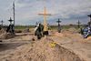 The grave of Mykhaylo Romaniuk, a civilian killed by Russian troops in the Yablunska street of Bucha, Kyiv region, is pictured in the cemetery of Bucha on April 25, 2022. According to a testimony, Romanyuk was shot dead by snipers on March 6, 2022 while riding his bicycle on Yablunska street. Romaniuk, was accompanying Oleksandr Smagliuk, 21, his niece's boyfriend, to the military hospital in the neighboring city of Irpin. The two men hoped to locate Smagliuk's father who had been seriously wounded by a shelling attack and was missing. They also thought they would find electricity there to charge their phones and call for help. - They all had different paths to death on Yablunska Street in Ukraine's tragedy-scarred Bucha: A risky evacuation, a borrowed bicycle, a missing parent - one among them was even from Russia. But at the end of that path, at least 20 people in civilian clothes met what is widely alleged to be an overt violation of war crimes law by Russia's invading forces. (Photo by Sergei SUPINSKY / AFP)