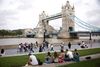 Tower Bridge can be seen as people walk along the River Thames, amid the coronavirus disease (COVID-19) pandemic in London, Britain, July 27, 2021. REUTERS/Henry Nicholls