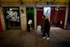 Et par går forbi en bar ved lukketid i Madrid lørdag aften. Fra søndag er der natligt udgangsforbud i hele Spanien bortset fra De Kanariske Øer. Foto:´Oscar del Pozo/AFP