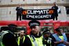 Police is seen as climate change activists demonstrate during the Extinction Rebellion protest, at Canary Wharf DLR station in London, Britain April 17, 2019. REUTERS/Henry Nicholls TPX IMAGES OF THE DAY