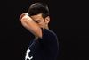 TOPSHOT - Novak Djokovic of Serbia attends a practice session ahead of the Australian Open tennis tournament in Melbourne on January 14, 2022. (Photo by MARTIN KEEP / AFP) / - -IMAGE RESTRICTED TO EDITORIAL USE - NO COMMERCIAL USE- -