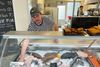 Tomas Rask Holm, medindehaver af Mato, har ikke hørt om nedlæggelse af parkeringspladserne ved busterminalen og er spændt på, hvad det kommer til at betyde for kundestrømmen til butikken. Foto: Helle Elgaard Kvist