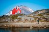 A resident of Kulusuk walks in Kulusuk, Greenland on August 20, 2019. - Denmark's prime minister said on August, 21, 2019 she was "annoyed and surprised" that US President Donald Trump postponed a visit after her government said its territory Greenland was not for sale, but insisted their ties remained strong. (Photo by Jonathan NACKSTRAND / AFP)