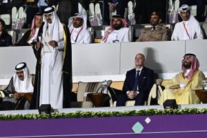 “VM kan gennemføres i sharialovens skygge,” synes emiren af Qatar at tænke, når han smiler til verdens medier fra VIP-loungen i selskab med Fifas præsident Infantino, skriver Rami Zouzou. På billedet ses de to i selskab med Saudi-Arabiens kronprins, Mohammed bin Salman (th.). Arkivfoto: Manan Vatsyayana