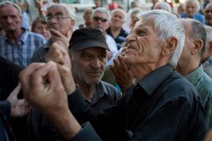 Græske pensionister i heftige diskussioner, mens de venter på at få adgang til deres bank, hvor de maksimalt må hæve 120 euro om dagen.