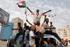 TOPSHOT - Sudanese protestors celebrate in the streets of Khartoum after ruling generals and protest leaders announced they have reached an agreement on the disputed issue of a new governing body on July 5, 2019. - The landmark agreement came after two days of talks following the collapse of the previous round of negotiations in May over who should lead the new ruling body - - a civilian or soldier. "The two sides agreed on establishing a sovereign council with a rotating military and civilian (presidency) for a period of three years or little more, " African Union mediator Mohamed El Hacen Lebatt told reporters. (Photo by ASHRAF SHAZLY / AFP)