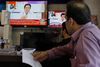 Shopkeepers listen the speech of Pakistani politician Imran Khan, chief of Pakistan Tehreek-e-Insaf party, telecasting on news channels at a shop in Islamabad, Pakistan, Thursday, July 26, 2018. Khan declared victory Thursday for his party in the country's general elections, promising a "new" Pakistan following a vote that was marred by allegations of fraud and militant violence. (AP Photo/Anjum Naveed)