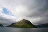 Færøerne er natur - krydret med en masse kultur. Her går fjeld, sol og skyer op i en højere enhed. Foto: Lars From