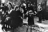 ** FILE ** In this April 19, 1943 file photo, a group of Jews, including a small boy, is escorted from the Warsaw Ghetto by German soldiers. The family of a Polish social worker Irena Sendler who is credited with rescuing 2,500 Jewish children from the Nazis during the Holocaust says she has died. Sendler's daughter, Janina Zgrzembska, says her 98-year-old mother died Monday, May 12, 2008, morning in a Warsaw hospital. Sendler organized the rescue of Jewish children from the Warsaw Ghetto during Nazi Germany's brutal World War II occupation. (AP Photo)