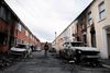 People inspect the damage in their neighbourhood, in the aftermath of anti-immigrant protests following a knife attack on June 8, which left a man seriously injured and prompted police to declare a critical incident, at Lendrick Street, east Belfast, Northern Ireland, June 10, 2026. REUTERS/Isabel Infantes TPX IMAGES OF THE DAY