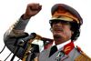 Libyan leader Moammar Gadhafi talks during a ceremony to mark the 40th anniversary of the evacuation of the American military bases in the country, in Tripoli, Saturday, June 12, 2010. (AP Photo/ Abdel Magid Al Fergany)