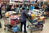 RICHMOND, CALIFORNIA - MARCH 13: A Costco customer stands by his two shopping carts at a Costco store on March 13, 2020 in Richmond, California. Some Americans are stocking up on food, toilet paper, water and other items after the World Health Organization (WHO) declared Coronavirus (COVID-19) a pandemic. Justin Sullivan/Getty Images/AFP == FOR NEWSPAPERS, INTERNET, TELCOS & TELEVISION USE ONLY ==