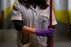 Cecilia Alvarez Velasco, 47, from Ecuador, poses for a picture as she works cleaning in a condominium residence in Barcelona on April 9, 2020 during a national lockdown to prevent the spread of the COVID-19 disease. (Photo by Josep LAGO / AFP)