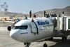 TOPSHOT - Afghan people climb atop a plane as they wait at the airport in Kabul on August 16, 2021, after a stunningly swift end to Afghanistan's 20-year war, as thousands of people mobbed the city's airport trying to flee the group's feared hardline brand of Islamist rule. (Photo by Wakil Kohsar / AFP)