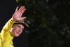 TOPSHOT - Jumbo-Visma team's Danish rider Jonas Vingegaard celebrates on the podium with the overall leader's yellow jersey after winning the 109th edition of the Tour de France cycling race, after the 21st and final 115, 6 km stage between La Defense Arena in Nanterre, outside Paris, and the Champs-Elysees in Paris, France, on July 24, 2022. (Photo by Thomas SAMSON / AFP)